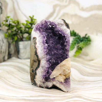 Amethyst Cluster with Calcite with decorations in the background