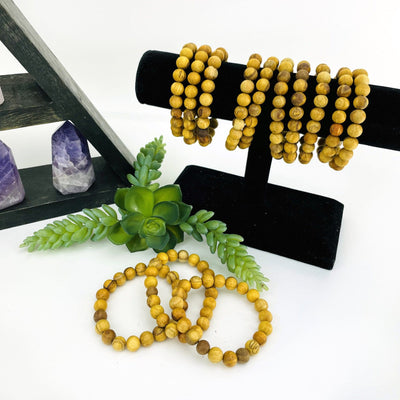 Palo Santo Round Bead Bracelets 8mm Beads on black velvet jewelry rack side view