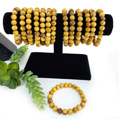Bundle of Palo Santo Round Bead Bracelets 8mm Beads in a black velvet jewelry rack 