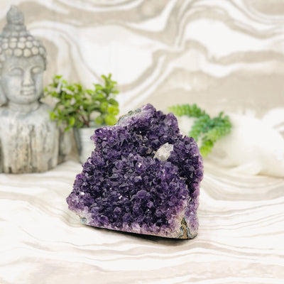 Amethyst Cluster with Calcite with decorations in the background