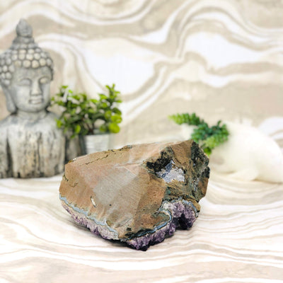 back view of Amethyst Cluster with Calcite with decorations in the background