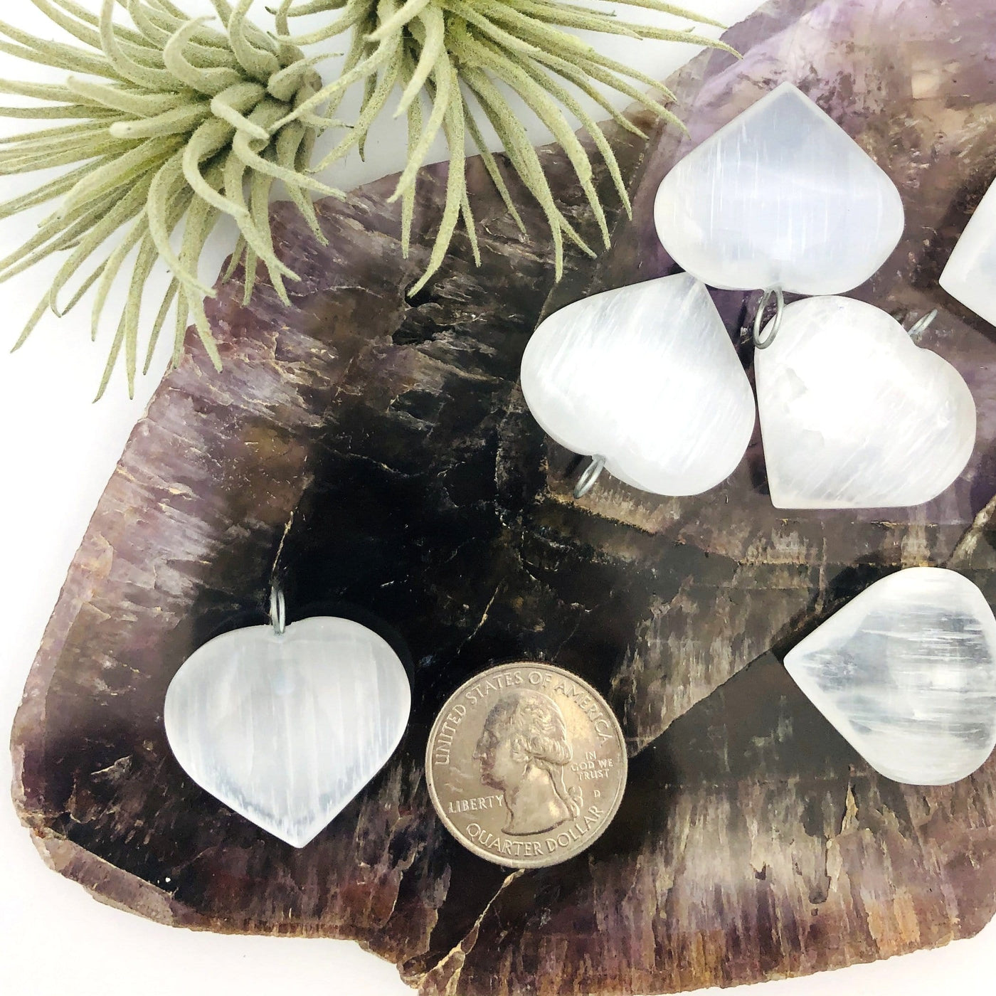 selenite heart pendant with quarter for size reference 