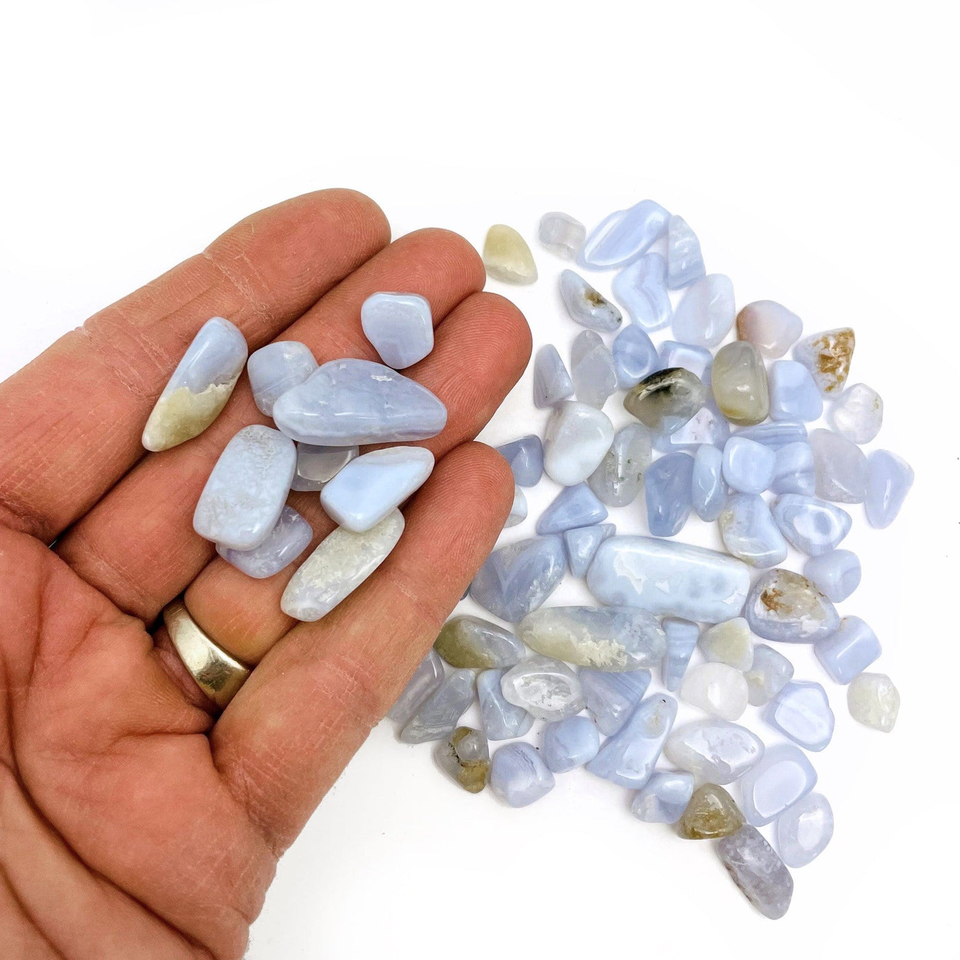 Blue Lace Agate Small Tumbled Stones with some in a hand for size reference