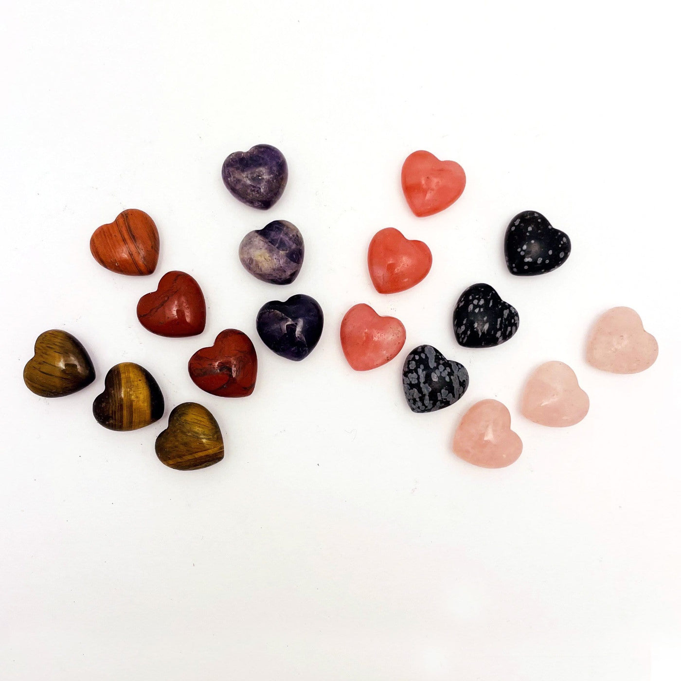 Stone hearts in all the available sgtones, tigers eye, red jasper, amethyst, strawberry quartz, rose quartz, snowflake obsidian fanned out on a table