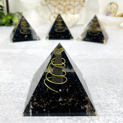Orgone Tourmaline with Pyrite Point Pyramid up close with 3 others in the back