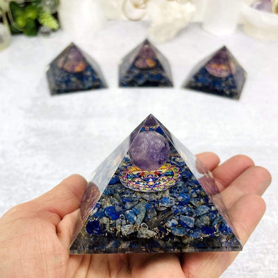 sodalite pyramid with amethyst sphere in hand for size reference