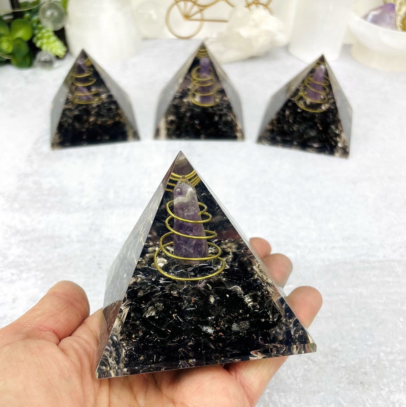 Orgone Pyramid displayed in hand for size reference