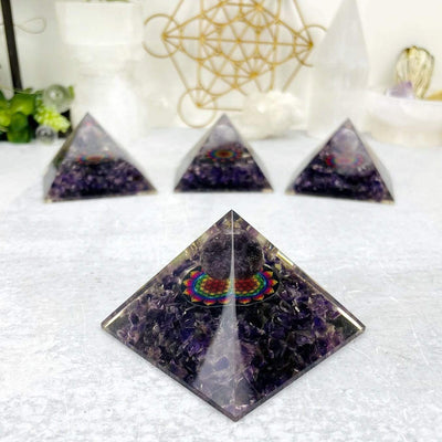 4 Orgone Amethyst Pyramids with Flower of Life Medallion, 1 up close and the others behind from another angle
