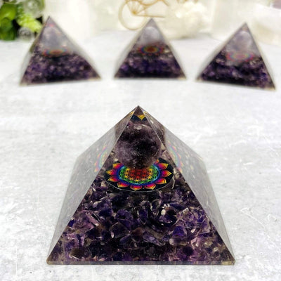 4 Orgone Amethyst Pyramids with Flower of Life Medallion, 1 up close and the others behind