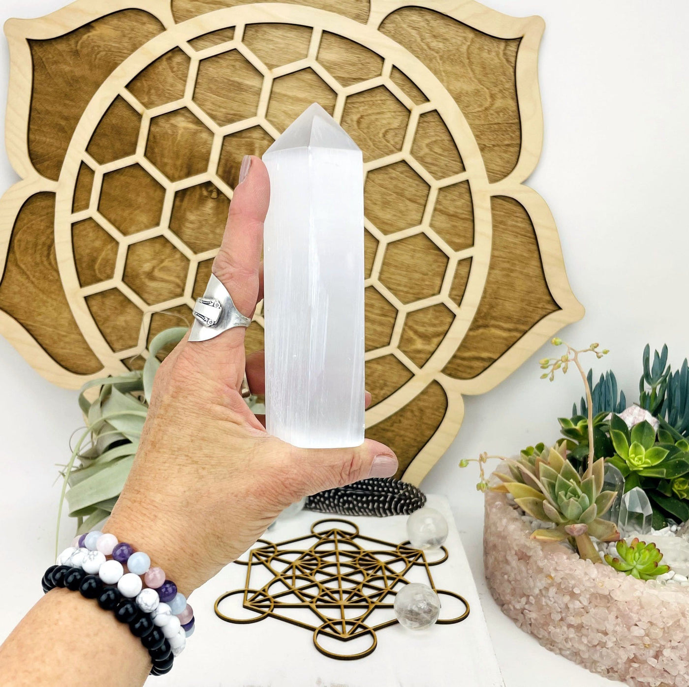 selenite point in hand for size reference 
