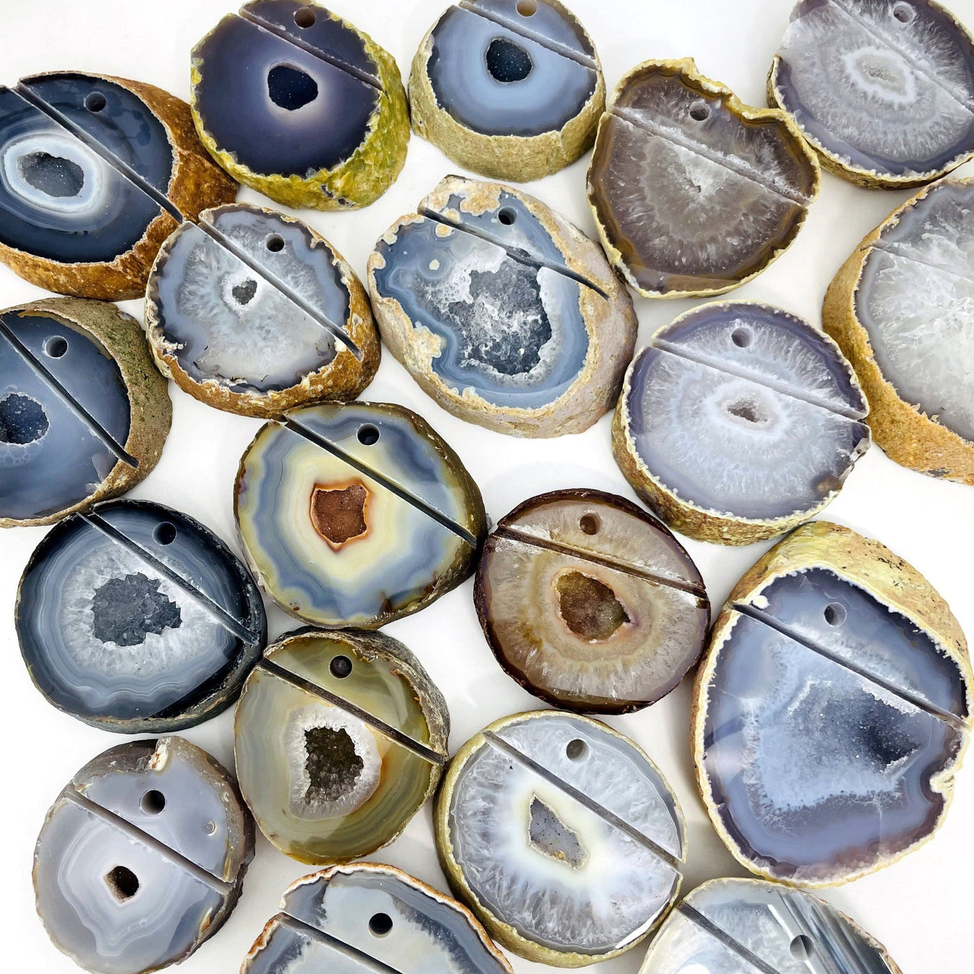 Picture of multiple agate pen holders being displayed, on a white background. 