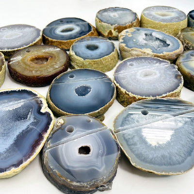 Picture of multiple agate pen holders being displayed, on a white background.