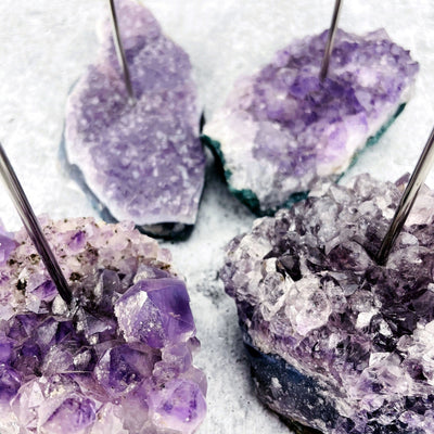close up into 4 amethyst candle holders.
