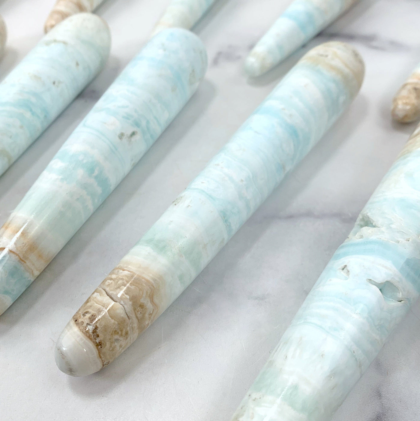 close up of wands from the side on marble background