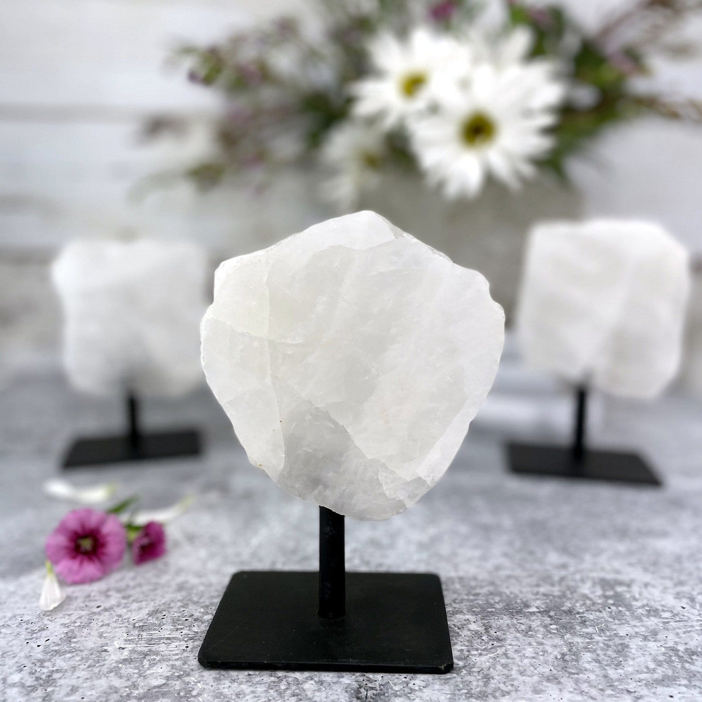 Polished Crystal Quartz Stone on Metal Stand With a Close up Of one piece