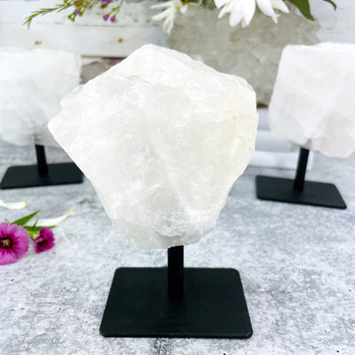 A close up of 1 Polished Crystal Quartz Stone on Metal Stand
