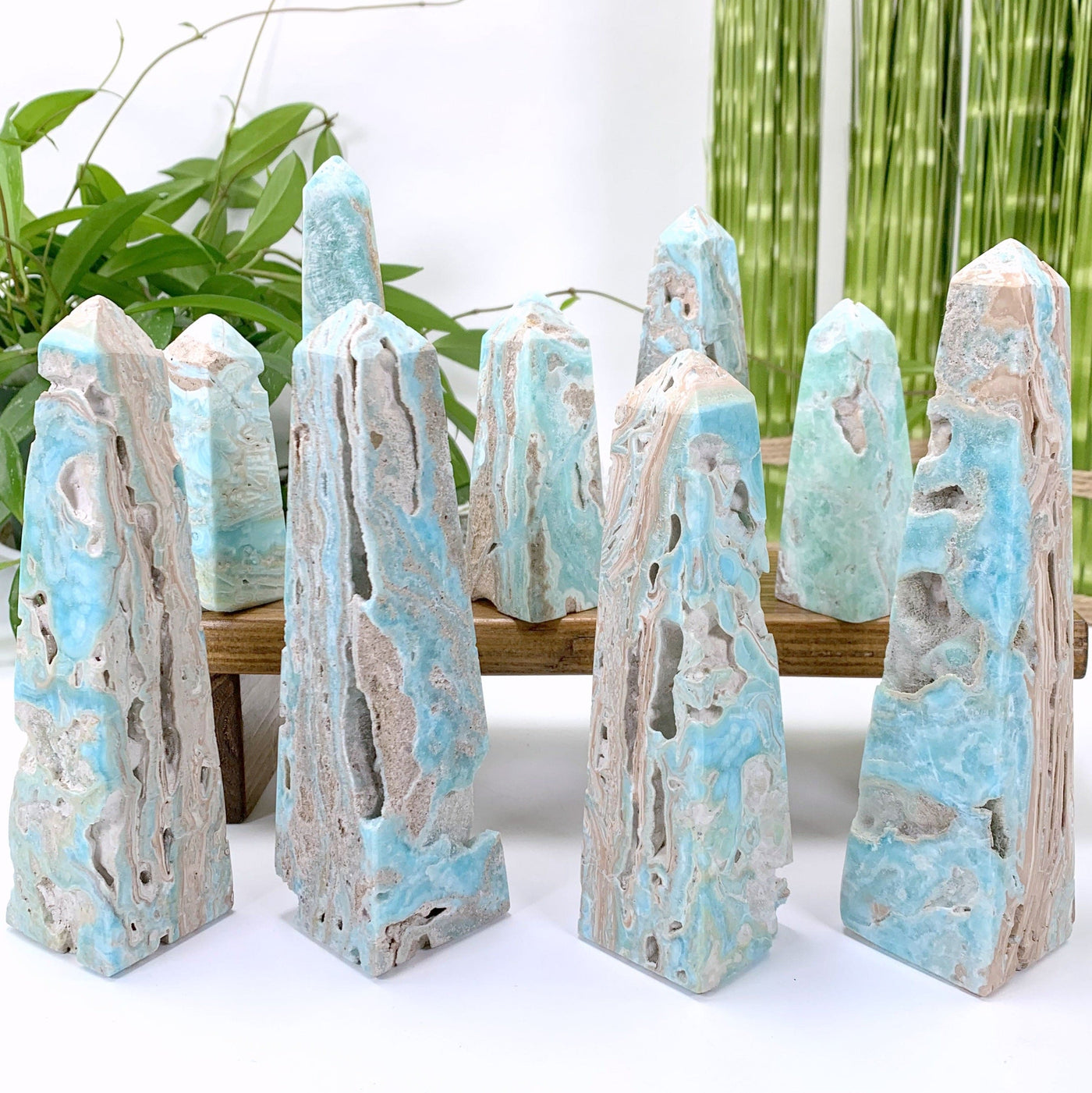10 obelisks sitting on a wood stand with a white background