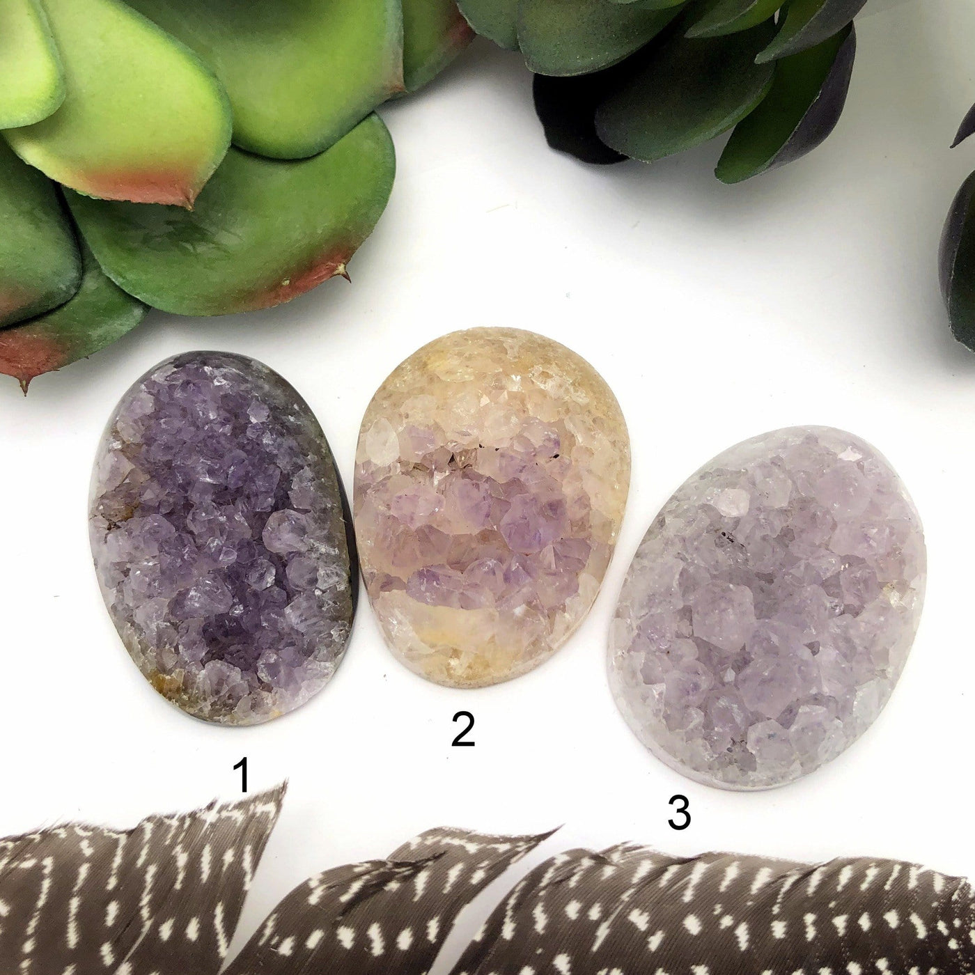 3 Polished Amethyst Crystal Clusters with decorations in the background