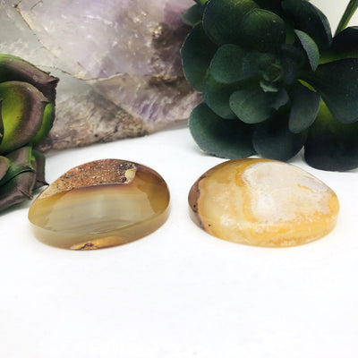 side view of both polished agate druzy stones