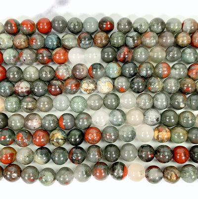 Close up of African Bloodstone Polished Round Beads on Strand.