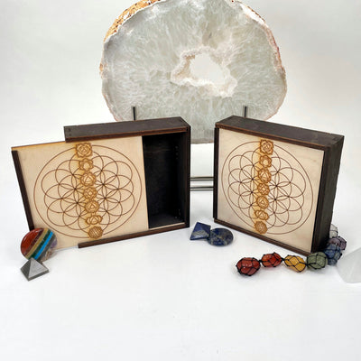 flower of life with seven chakra wooden storage box propped up in front of backdrop