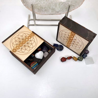 overhead view of flower of life with seven chakra wooden storage box with crystals inside (not included with purchase)