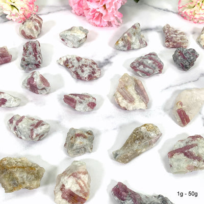 atural Pink Tourmaline with Mica on Matrix - laying on a table