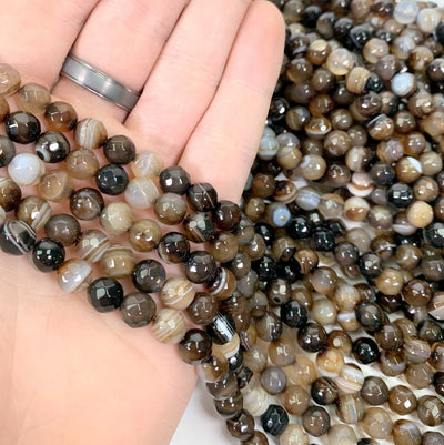 dyed brown agate beads in hand