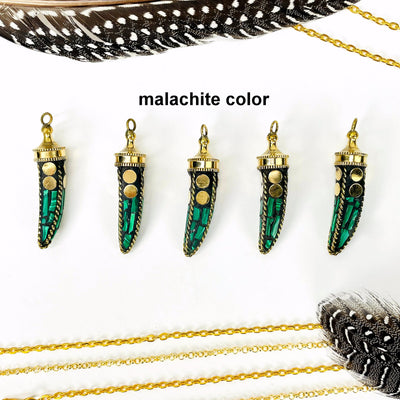 overhead view of five malachite color petite mosaic horn pendants in a row on white background with decorations for possible variations