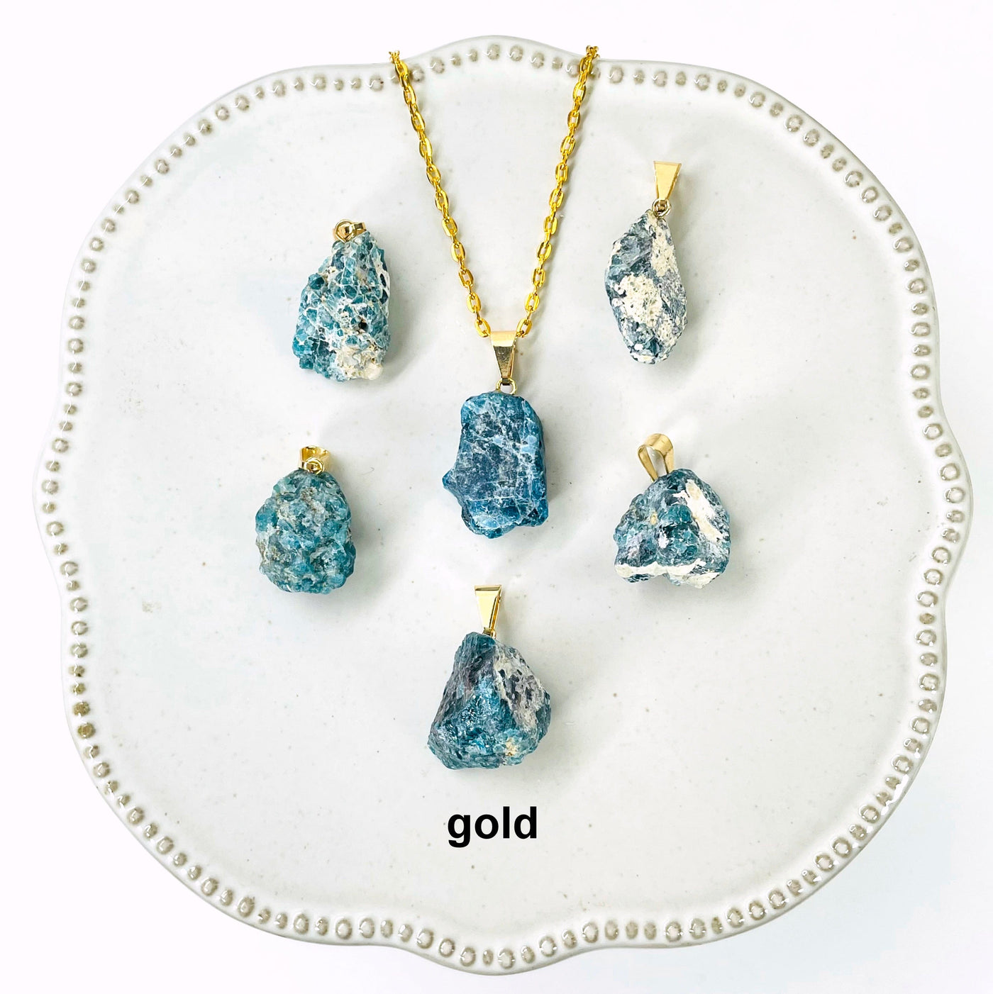 six gold raw blue apatite chunk pendants on display for possible variations