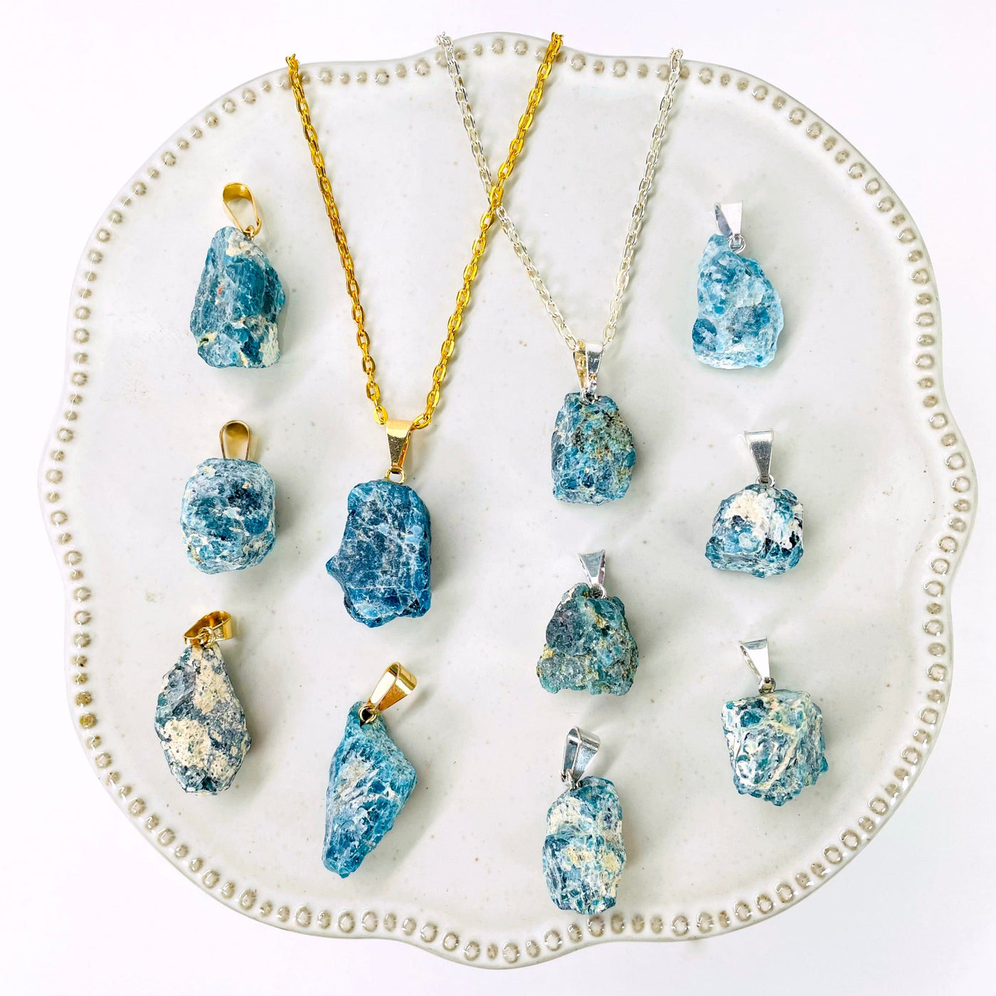 many gold and silver raw blue apatite chunk pendants on display for possible variations and finish comparison