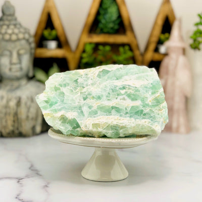 Fluorite Freeform on stand with decorations in the background