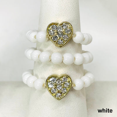 close up of three white heart elastic rings on ring display