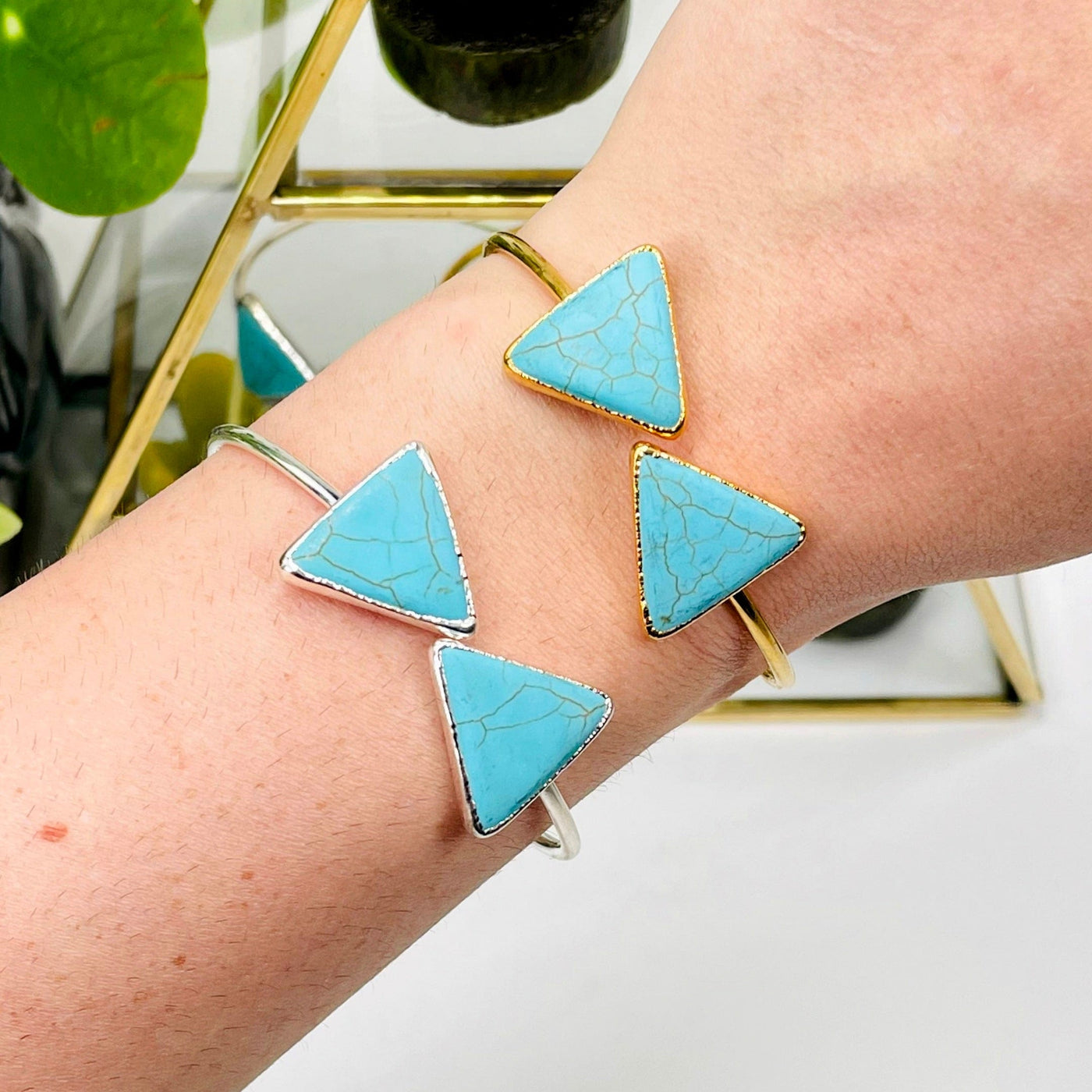 one gold and one silver turquoise howlite double triangle adjustable bracelet on wrist