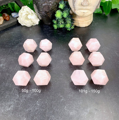 2 groups of Rose Quartz Dodecahedrons, 1 50-100g the other 101-150g, with decorations in the background