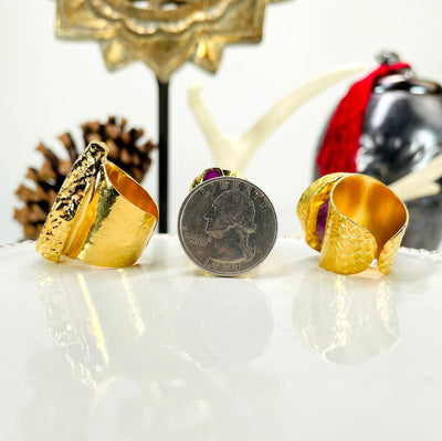 close up of three colored agate druzy gold adjustable rings with a quarter for size reference