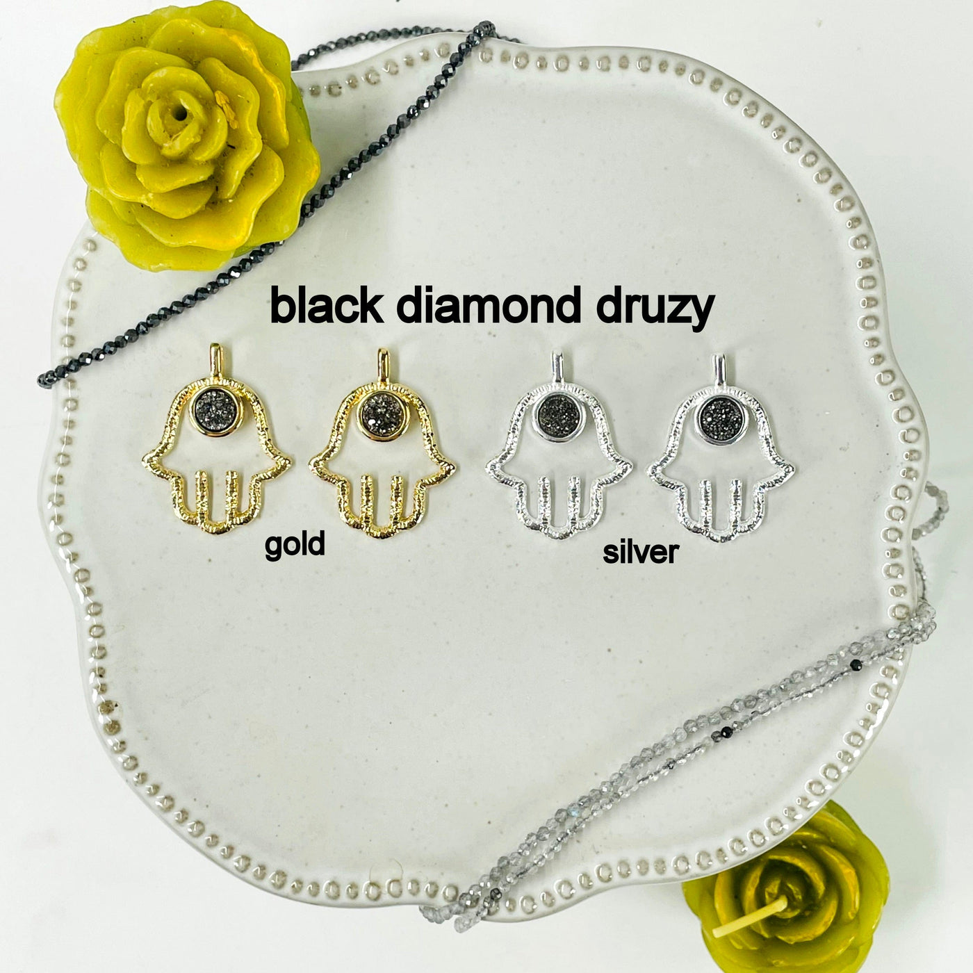 two gold and two silver hamsa hand pendants with black diamond druzy accent