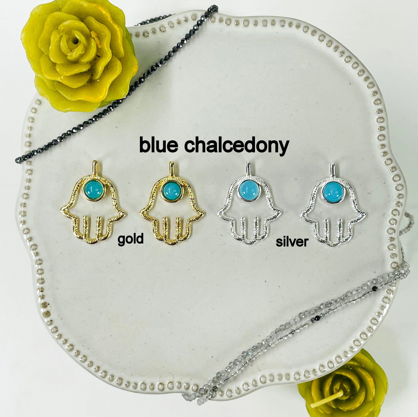 two gold and two silver hamsa hand pendants with blue chalcedony accent