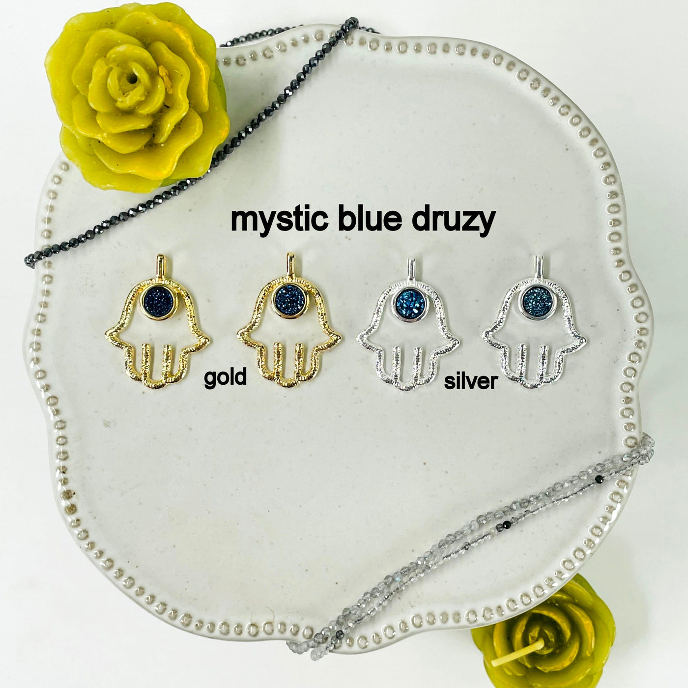 two gold and two silver hamsa hand pendants with mystic blue druzy accents