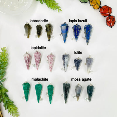three labradorite, lapis lazuli, lepidolite, lolite, malachite, and moss agate pendulum pendants on white background for possible variations 