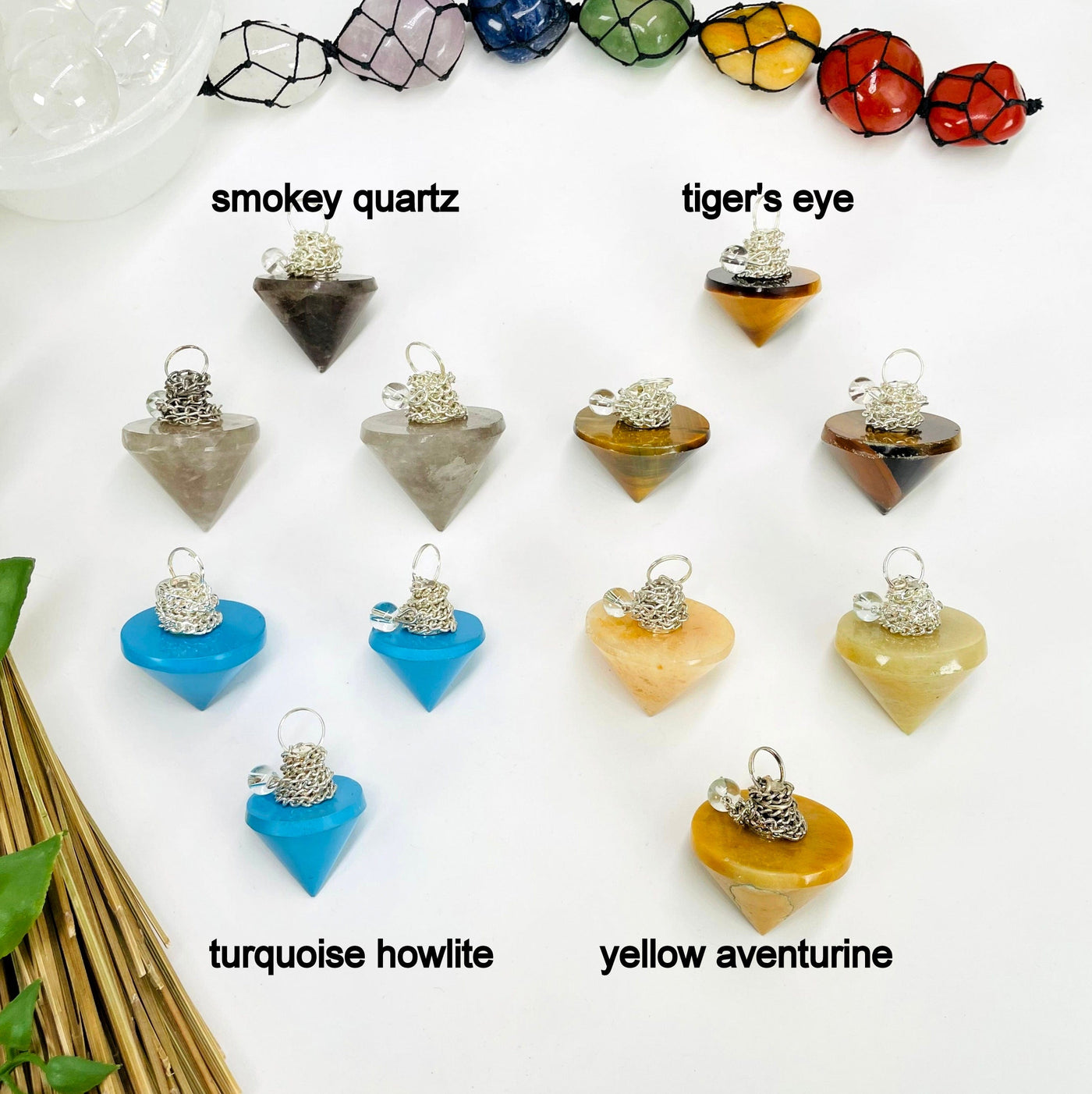 three smokey quartz, tiger's eye, turquoise howlite, and yellow aventurine pendulum pendants on white background for possible variations