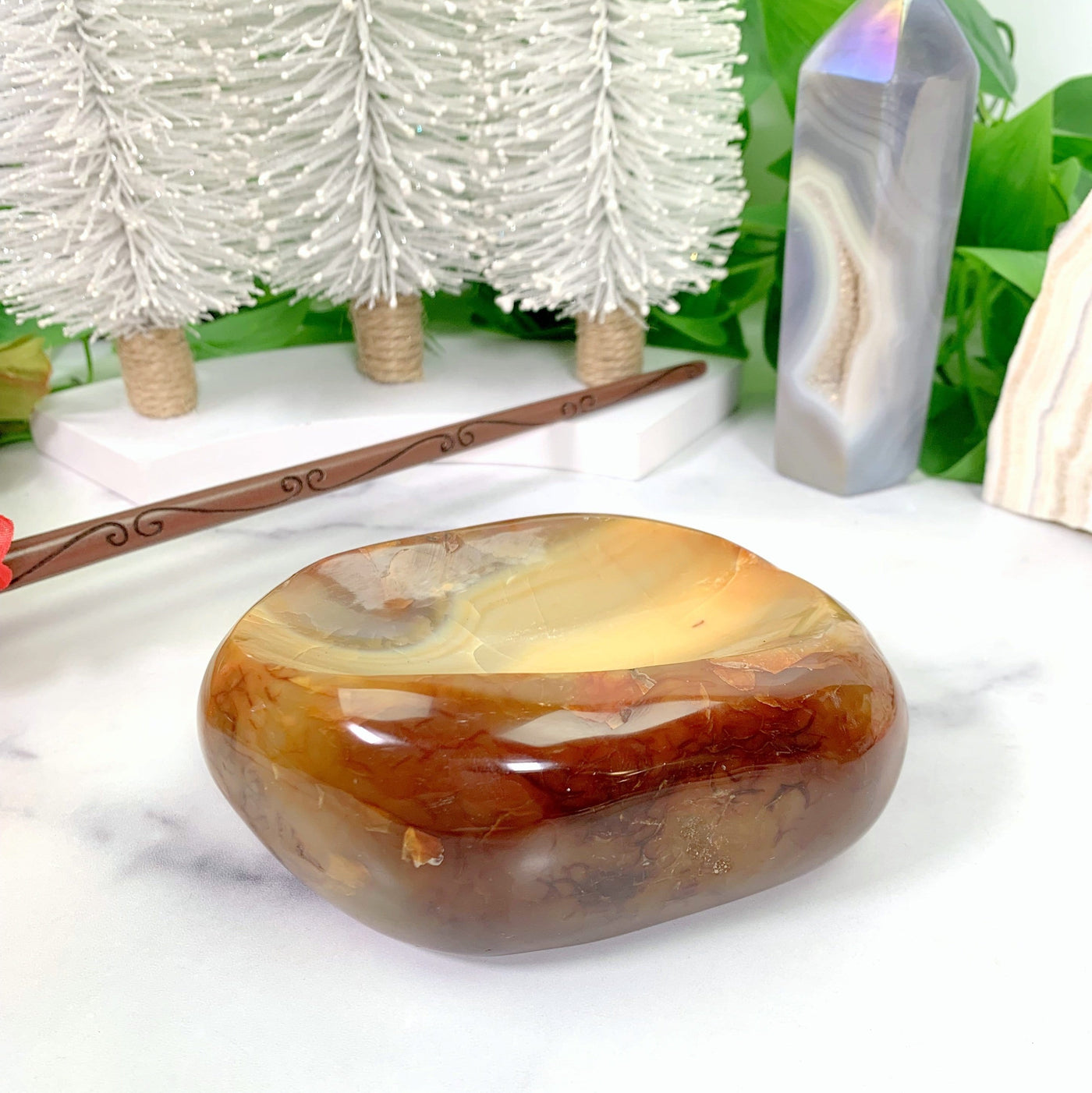 Polished Carnelian Decorative Bowl with decorations in the background