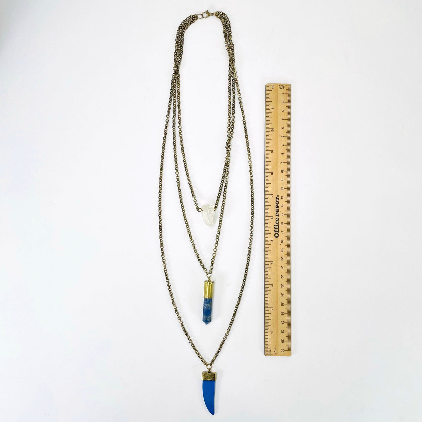 full necklace length on white background with a ruler for length reference
