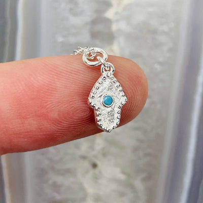 one hamsa hand pendant on one finger for size reference