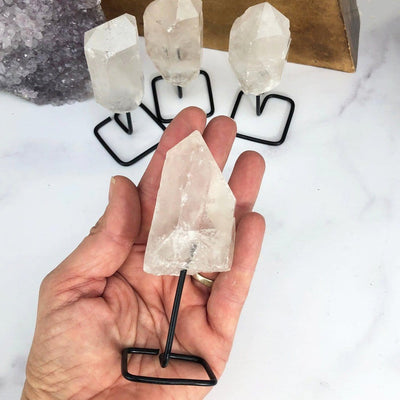 Products Natural Stone Crystal on Metal Stand - in a hand