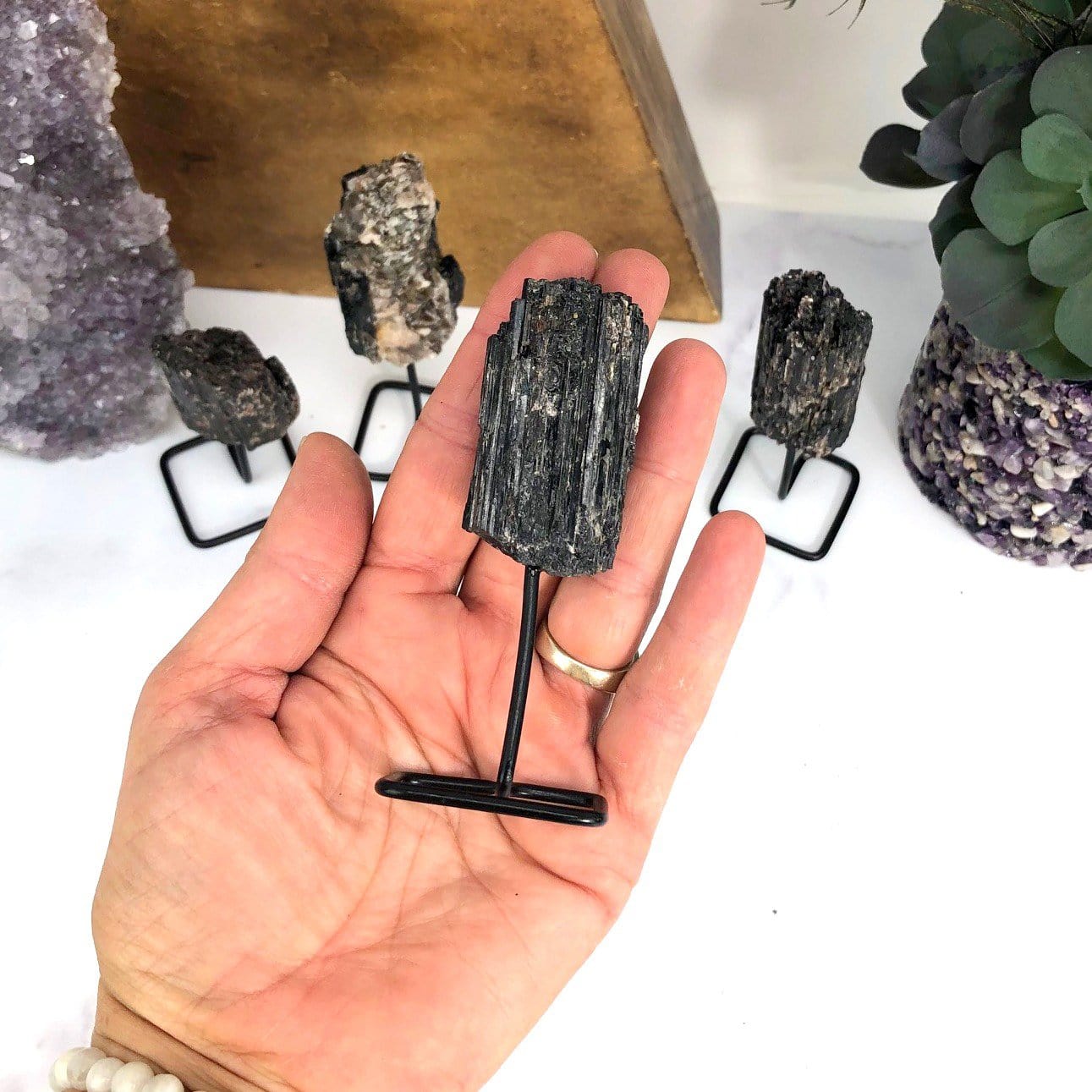 Products Natural Stone Crystal on Metal Stand - one in a hand