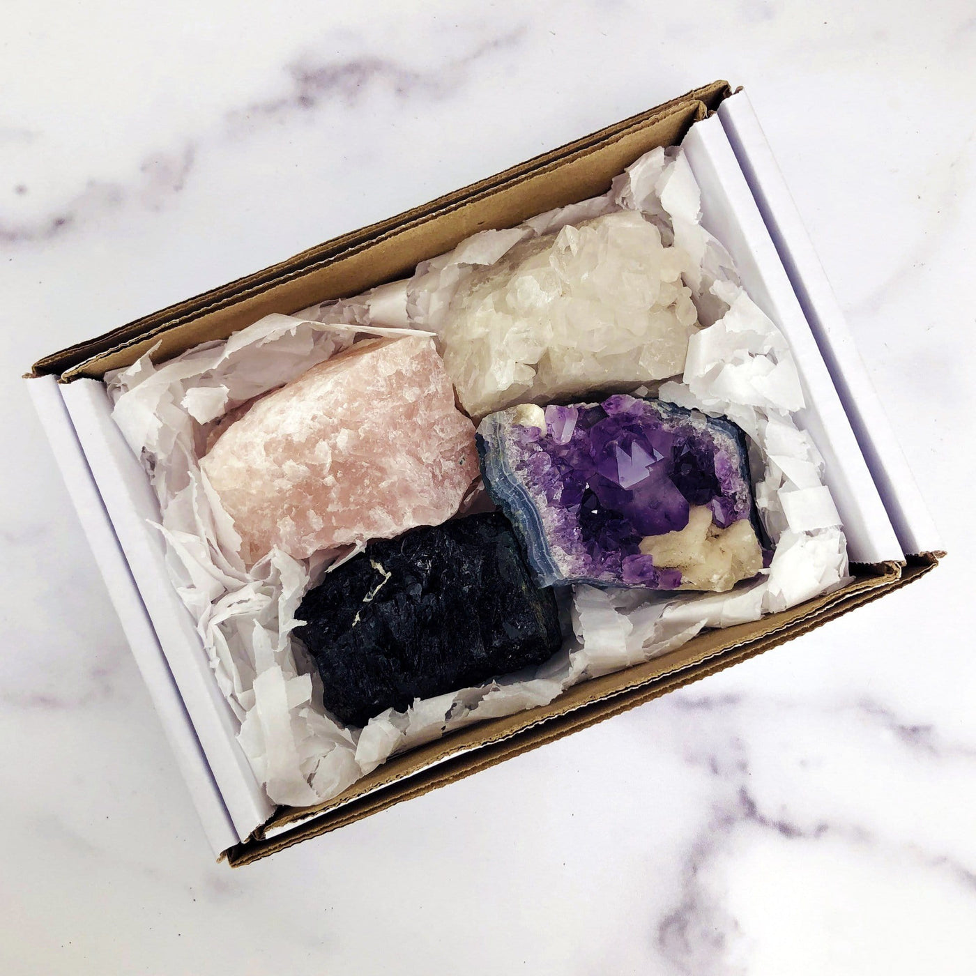 white box with rose quartz crystal quartz cluster amethyst cluster and black tourmaline inside