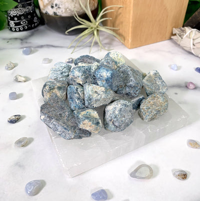 closer angle of 1 pound blue apatite stones on white marble background