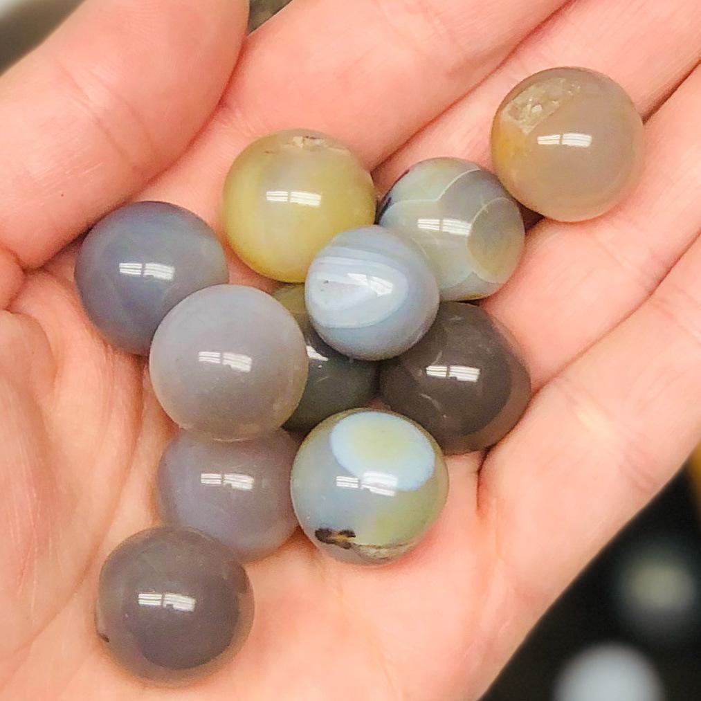 Picture of agate spheres being held.
