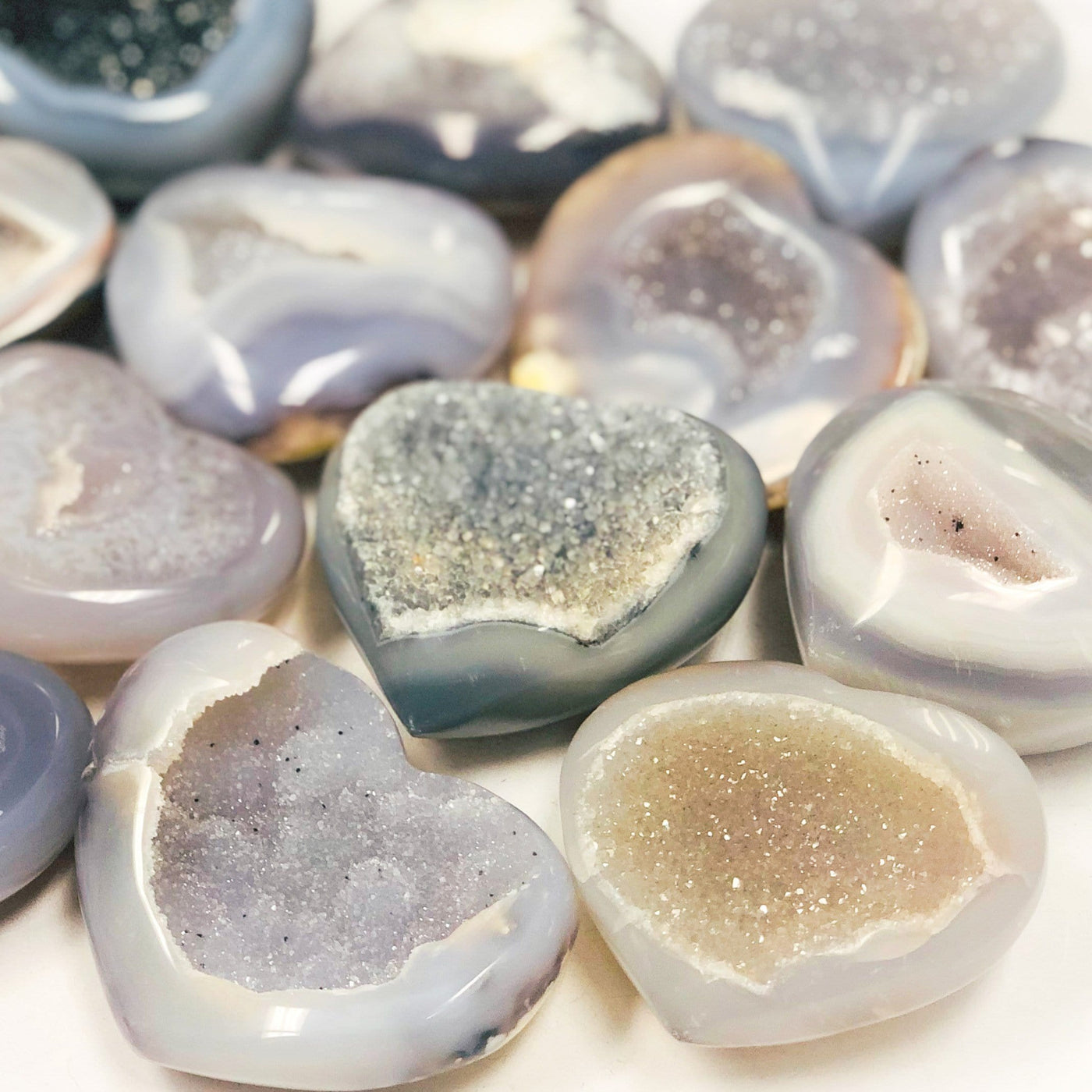 Close up of agate hearts with druzy on a white background. 